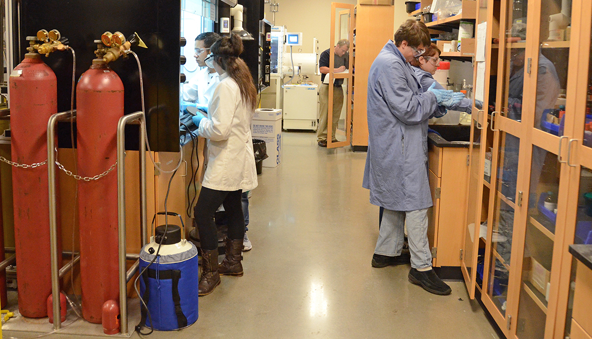 Project SEED students make sure excess substance is off stir bars.