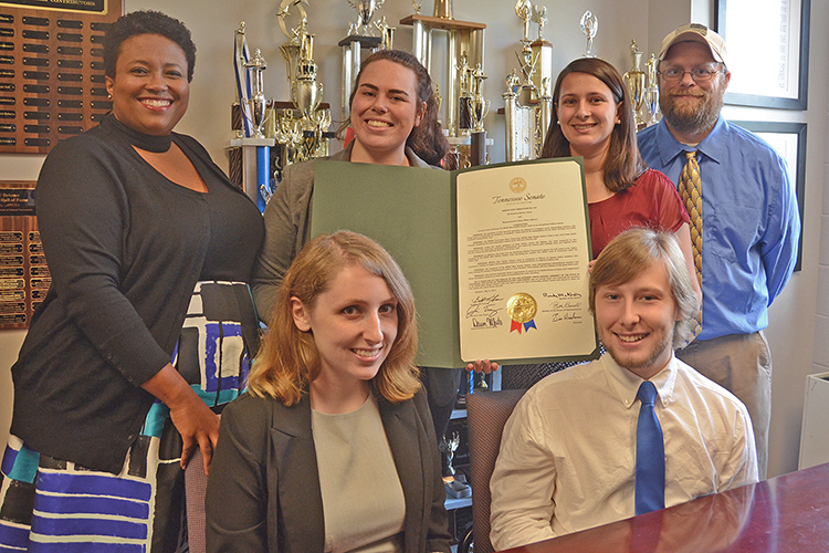 Some of the members of the Blue Raider Debate team are shown inside their office in Jones Hall with the Tennessee Senate Joint Resolution presented to the team earlier this year. Pictured are, seated front row from left, Jordan Nickell, a junior interactive media and sociology major from Jackson, Tenn.; and Alex Fingeroot, a religious studies, political science and history major from Tallahassee, Fla. Back row, from left, are Natonya Listach, assistant coach and instructor in communication studies and organizational communication; Katelyn Brooks, a senior communication studies and anthropology major from Nashville; Skye Irish, a senior political science major from Rockwood, Tenn.; and Pat Richey, debate team coach and director of forensics at MTSU. (MTSU photo by Jimmy Hart)