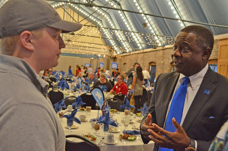 Ben Boney, left, a senior at the L&N STEM Academy in Knoxville, Tenn., listens as MTSU President Sidney A. McPhee asks about his interests and what he would study if he chooses to attend the Murfreesboro university. The exchange happened during the MTSU True Blue Tour event Oct. 26 at The Foundry on the Fair Site in Knoxville. (MTSU photo by Randy Weiler)