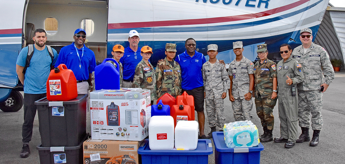 Members of the MTSU Raider Relief team are shown Wednesday, Nov. 15, at the airport in San Juan, Puerto Rico, with volunteers from the Puerto Rico Wing of the Civil Air Patrol. The group was preparing to distribute a load supplies flown to the island by Raider Relief to assist the family of former Blue Raider basketball star Raymond Cintron. (MTSU photo by Andrew Oppmann)