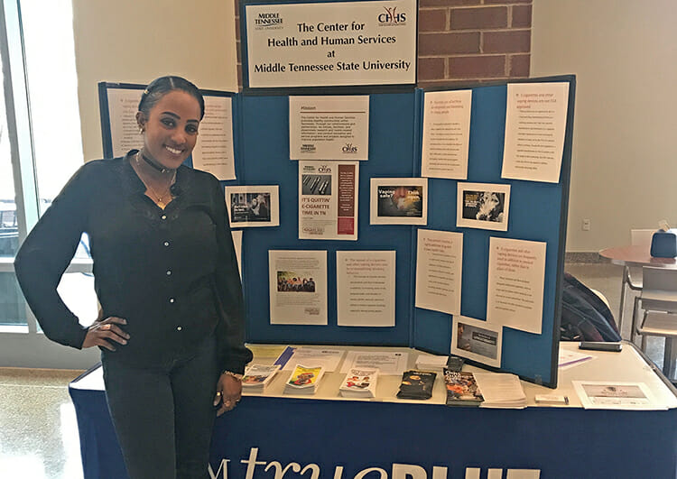 MTSU student Yemi Belachew stands next to a display table set up Feb. 7 in the Student Union Atrium as part of the MTSU Center for Health and Human Services’ support of the Tennessee Quit Week anti-smoking campaign. Balachew is a health and human performance major interning at the center this spring. (Submitted photo)
