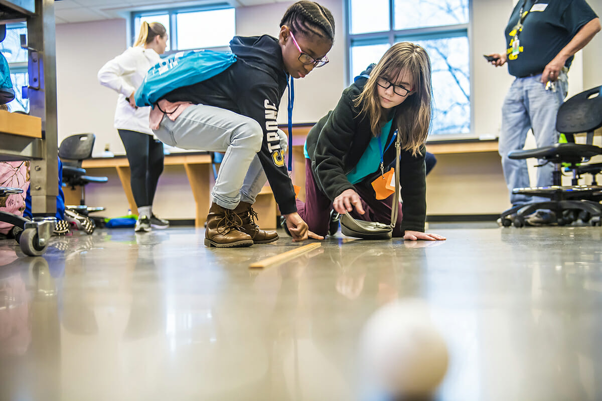 Middle school students check a measurement during the Feb. 10 EYH at MTSU.