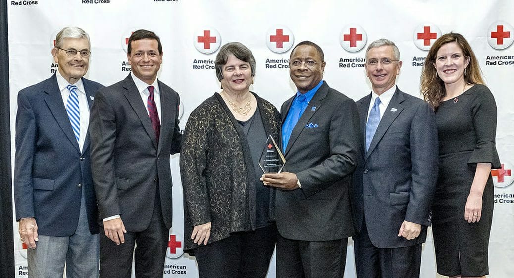 Middle Tennessee State University President Sidney A. McPhee, third from right, holds the 2018 Hero Award during the American Red Cross Heroes Breakfast held Feb. 21 inside the MTSU Student Union Ballroom. Pictured, from left, are John Hood, MTSU director of community engagement and support; MTSU alumnus and multimedia professional and former TV anchor Nick Paranjape; Linda Gilbert, director of Murfreesboro City Schools; McPhee; Gordon Ferguson, president and CEO of Saint Thomas Rutherford Hospital; and Kathy Ferrell, executive director, American Red Cross Heart of Tennessee Chapter. (MTSU photo by J. Intintoli)