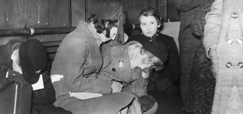 Young Jewish refugees, tired from the last leg of their journey from Germany, sit on benches after their arrival in the southeast English coastal town of Harwich, Essex, in the early morning of Dec. 2, 1938. Two hundred youngsters between ages 12 and 17, mostly from Berlin and Hamburg, were the first wave of young Jewish refugees fleeing the Nazis in what would become known as the Kindertransport and would eventually bring almost 10,000 children, some still infants, into Great Britain. (Photo courtesy of Planet News Ltd., London/German Federal Archive)