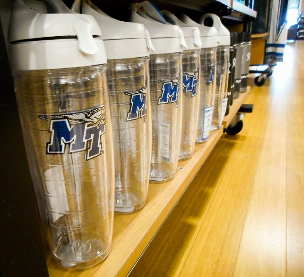 Clear MTSU reusable water bottles sit on a shelf in the MTSU Phillips Bookstore.