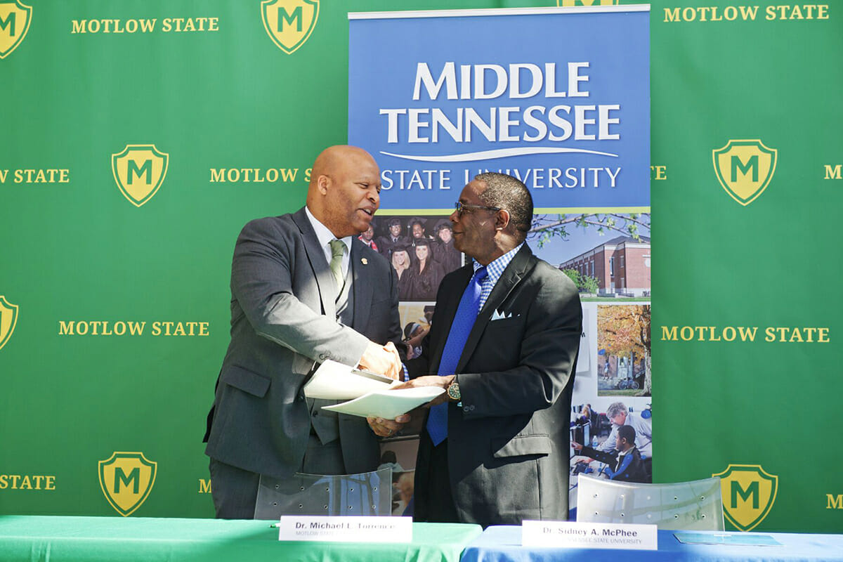 MTSU and Motlow State presidents confirm the agreement with a handshake.