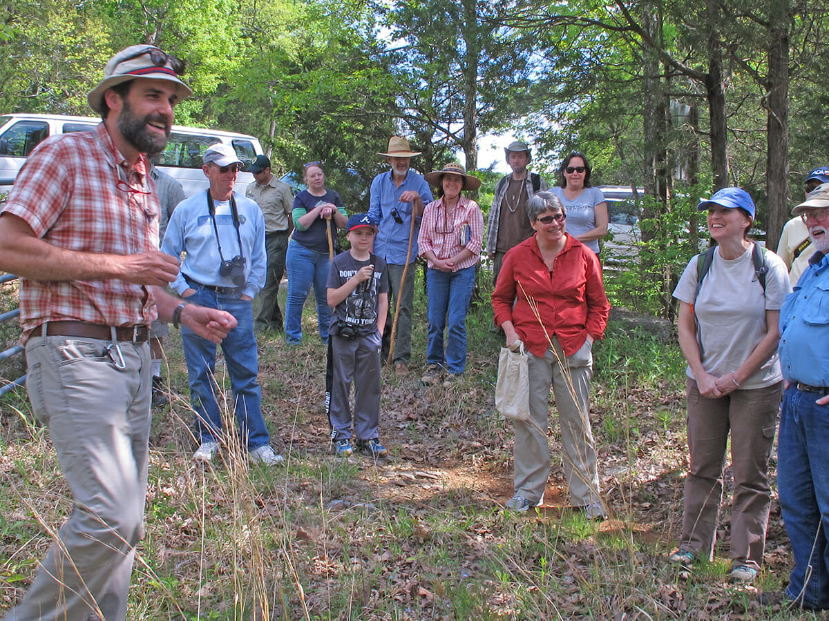 Roger McCoy leads a group through the cedar glades at Cedars of Lebanon State Park.