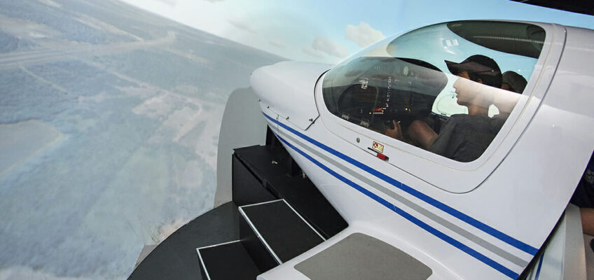 Thomas Kelly, 12, left, and Graham Jones, 15, fly one of the flight simulators Thursday, June 14, at the Murfreesboro Airport during the 2018 Introduction to Aviation and Professional Pilot Advanced Camp. (MTSU photo by Andy Heidt)