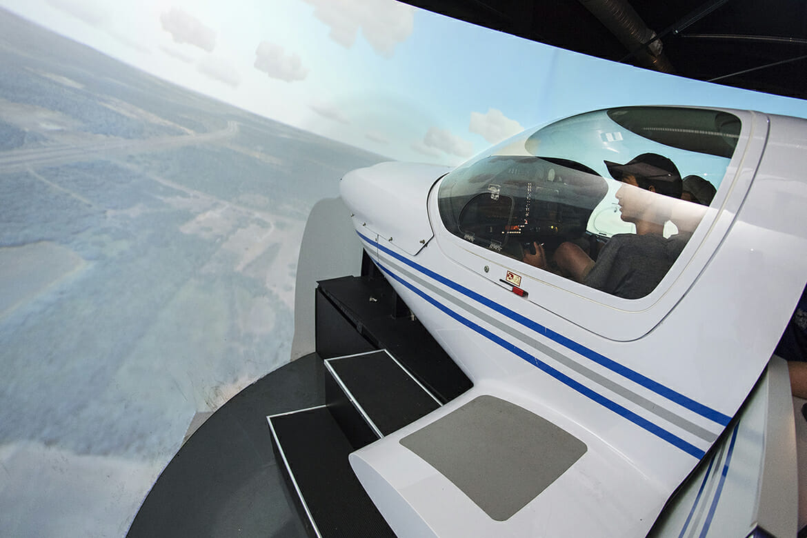 Thomas Kelly, 12, left, and Graham Jones, 15, fly one of the flight simulators Thursday, June 14, at the Murfreesboro Airport during the 2018 Introduction to Aviation and Professional Pilot Advanced Camp. (MTSU photo by Andy Heidt)