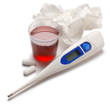 A thermometer, tissues, and cough syrup