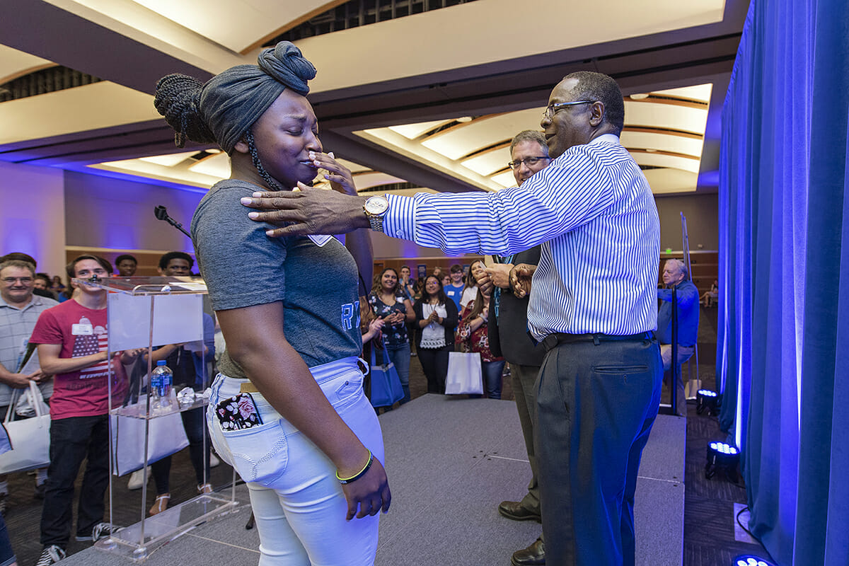 Now an MTSU freshman, Christan Lee, left, of Christiana, Tenn., and Centennial High School graduate, reacts with emotion after receiving a $2,500 scholarship to MTSU from Provost Mark Byrnes, center, and MTSU President Sidney A. McPhee while attending the Murfreesboro and Rutherford County True Blue Tour event in August 2018. MTSU kicks off the 2019 True Blue Tour campaign at 6 p.m. Wednesday, Aug. 21, in the Student Union Ballroom, the first of 14 tour stops this fall. (MTSU file photo by Andy Heidt)