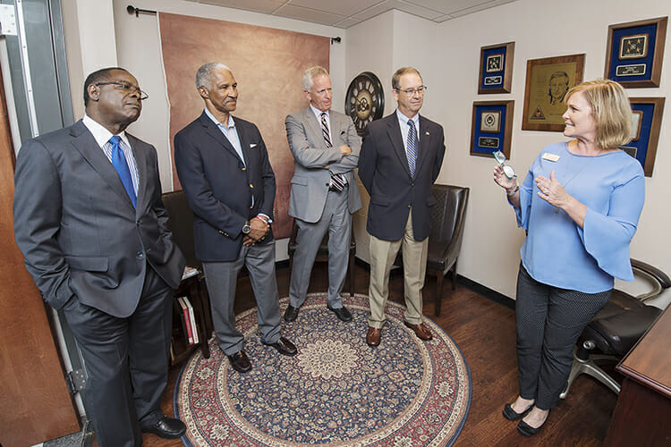 From left, MTSU President Sidney A. McPhee; State Farm agent Tom Clark; developer Bob Parks; and State Farm agent Bill Cunningham listen as Laura Buckner, instructor in the Department of Marketing, explains the resources available in the Mel Adams State Farm Sales Lab following a ribbon-cutting for the lab Tuesday, Aug. 7, inside the Business and Aerospace Building. Supported by a $50,000 endowment by State Farm agents, the lab allows students in the Professional Selling concentration to conduct and record mock interviews and review them with faculty to identify areas of improvement. (MTSU photo by Andy Heidt)