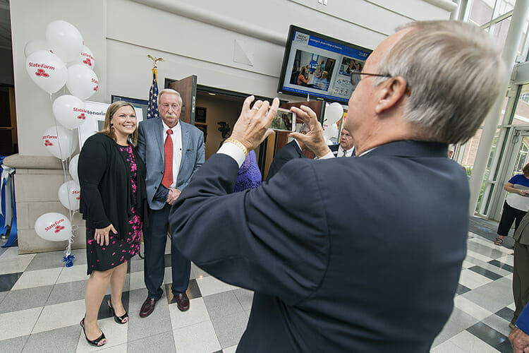 Andy Womack, MTSU alumnus and State Farm agent, takes a picture Tuesday, Aug. 7, of his daughter, Dana Womack, left, and Mel Adams outside of the Mel Adams State Farm Sales Lab inside Business and Aerospace Building following a ribbon-cutting ceremony for the lab. Supported by a $50,000 endowment by State Farm agents, the lab allows students in the Professional Selling concentration to conduct and record mock interviews and review them with faculty to identify areas of improvement. (MTSU photo by Andy Heidt)