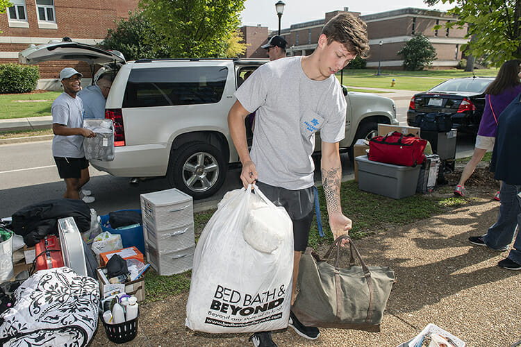 MTSU sophomores Blake Borcherding, right, and Darion Campbell, left, help unload a vehicle during We-Haul move-in Friday, Aug. 24, at Corlew Hall. Volunteers helped hundreds of students get settled into their dorms in preparation for the start of fall semester classes Monday, Aug. 27. (MTSU photo by Andy Heidt)