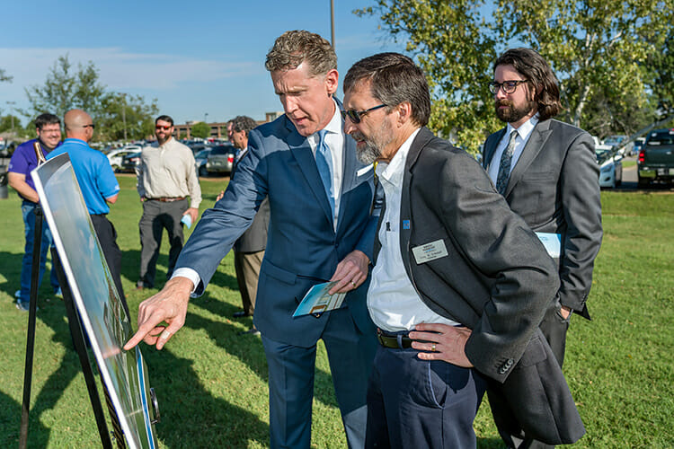 Greg Schmidt, right, chair of the MTSU Department of Psychology, and Tom Bauer, architect and principal at Bauer Askew Architecture PLLC in Nashville, Behind them is Bauer Askew architect Ross Hamilton. 