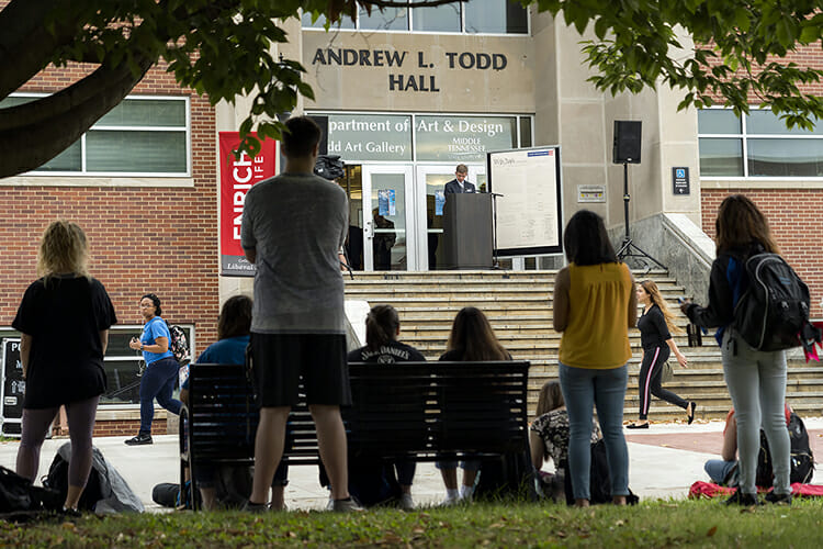 A small crowd listens carefully to the words of the U.S. Constitution being read on the steps of MTSU's Todd Hall Monday, Sept. 17, to help kick off the university's celebration of Constitution Day. Students, faculty, staff, volunteers and guests read the Constitution at sites across campus all day to celebrate the 231st anniversary of the document's signing, and voter registration is the focus of the week. (MTSU photo by J. Intintoli)