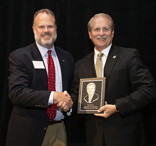Insurance agent Derek Wirz, left, a member of the Insurance Liaison Committee for the Robert E. Musto Tennessee Insurance Hall of Fame, congratulates fellow agent and Rutherford County Mayor Bill Ketron Sept. 20 during the Class of 2018 banquet and induction ceremony held at Embassy Suites in Murfreesboro. (MTSU photo by Eric Sutton)