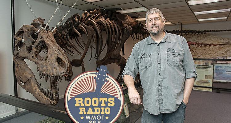 Alan Brown, a geosciences lecturer at MTSU, poses with a full-sized replica of a T. rex dinosaur at "Earth Experience: The Middle Tennessee Museum of Natural History" in Murfreesboro. Brown is the guest on the Sept. 11 and 16 editions of "MTSU On the Record." (MTSU file photo by Andy Heidt)