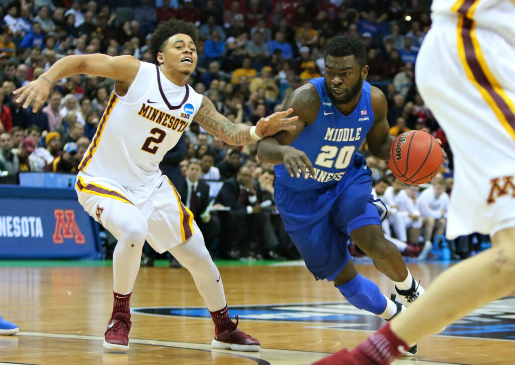 MTSU Men's Basketball guard, Giddy Potts, drives past Minnesota defender in March Madness upset win. Photo by Brent Beerends.