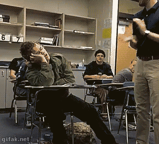 A boy in class is asleep, and wakes up as his class claps at him. He joins in without knowing why.