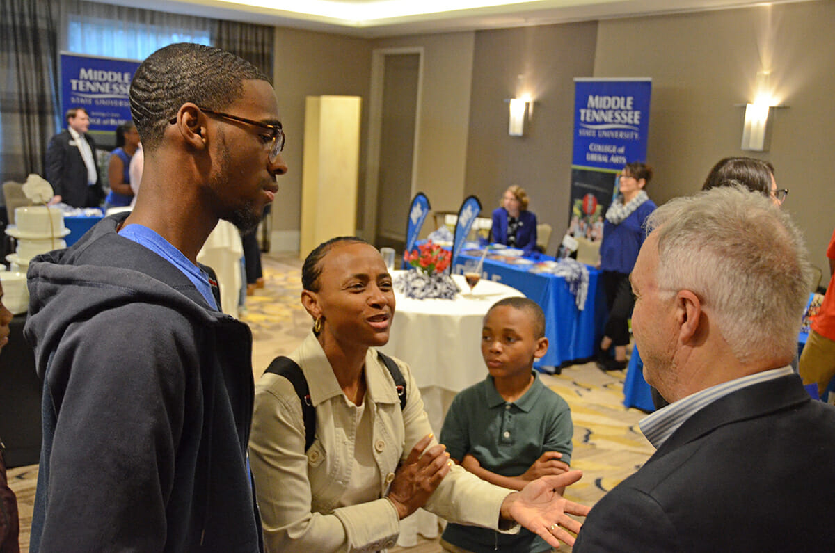 Ken Paulson, right, president of the Freedom Forum’s First Amendment Center at MTSU, listens as Teresa McKenzie, second from left, asks questions about the variety of programs within the college. Ryan McKenzie, 17, a junior at Arabia Mountain High School in Lithonia, Ga., listens during the MTSU True Blue Tour visit at the Hyatt Regency Perimeter in Atlanta, Ga., in October 2018. Also shown is Rance McKenzie, 9. Ryan McKenzie won a $1,500 scholarship. MTSU and the tour return to Atlanta Wednesday, Oct. 30. (MTSU file photo by Randy Weiler)