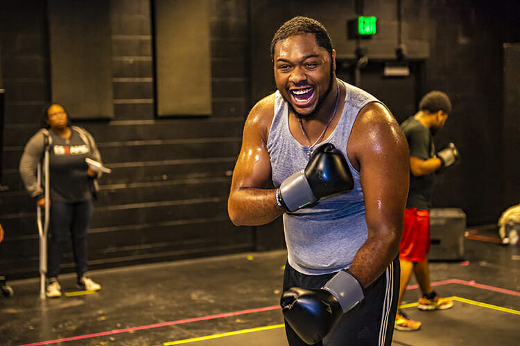 MTSU junior Devin Bowles of Jackson, Tenn., gets into character as boxer Jay "The Sport" Jackson during rehearsals for the MTSU Theatre production of "The Royale," set Oct. 11-13 and Oct. 17-21 in the Anderson Studio Theatre. Looking on is director KT Turner, a Murfreesboro senior, while freshman Jamil Parrish of Nashville, who portrays Fish, Jackson's sparring partner, walks around the boxing "ring." Tickets are available at www.mtsuarts.com. (MTSU photo by Eric Sutton)