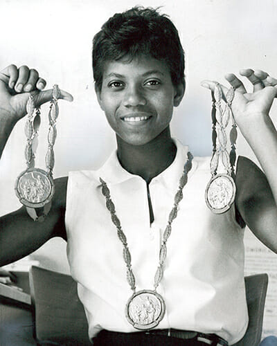 Clarksville, Tenn., native Wilma Rudolph displays her three gold medals after the 1960 Olympics in Rome, where she and her fellow Tennessee State University Tigerbelles exploded their growing legends as the queens of track and field. Rudolph, who survived polio as a child, won her first medal, a bronze, in the 1956 Melbourne Olympics' 4 x 100-meter relay, then became a world icon four years later with golds in the 100- and 200-meter dash events and again in the team 100-meter relay. She was the first American woman to win three golds in a single Olympic Games. "Mr. Temple and the Tigerbelles," a new documentary about the team and their coach, Ed Temple, created by an Academy Award-nominated MTSU Media Arts film professor and students and faculty from across the College of Media and Entertainment, will have a free public preview Thursday, Oct. 18, at the Nashville Public Library's Main Branch. (Photo courtesy of Tennessee State University)