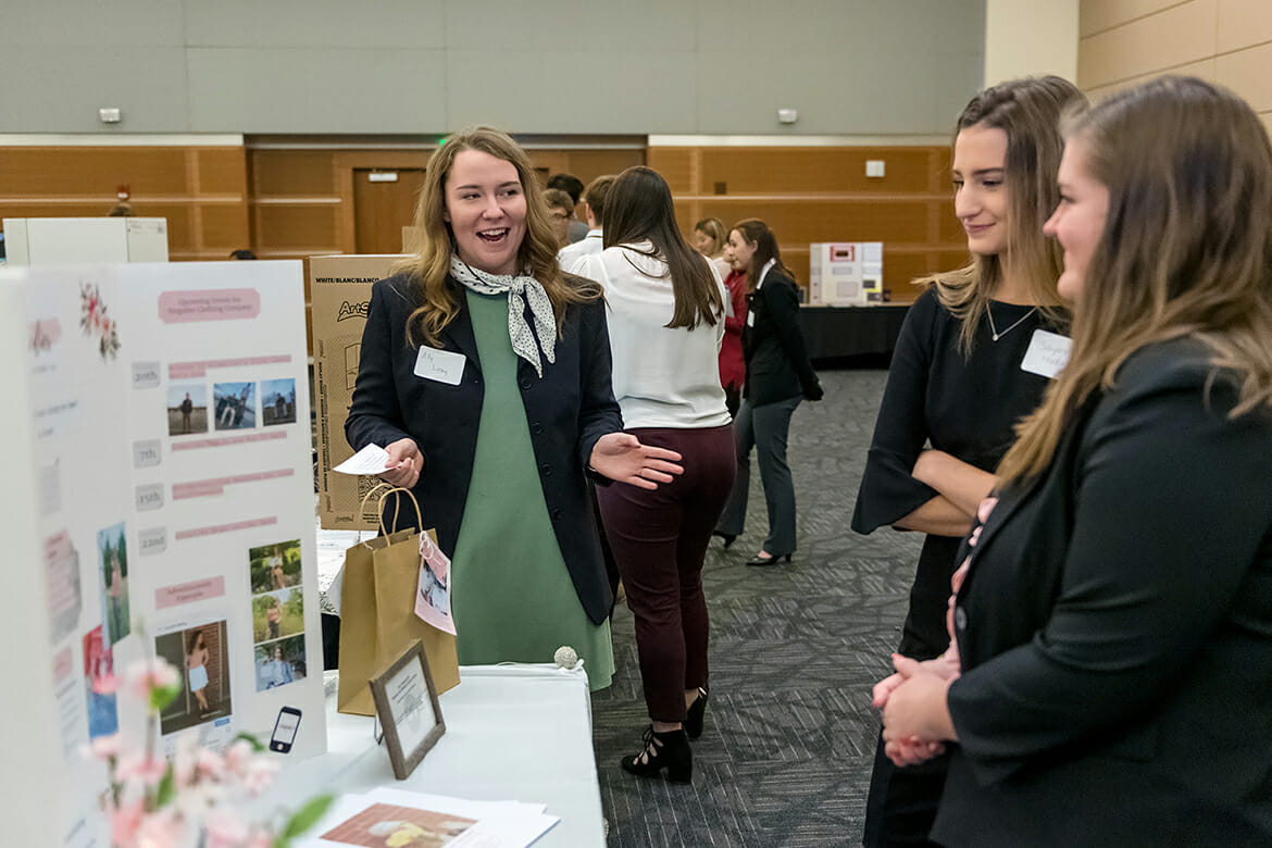 Summit High School student Ally Losey, left, explains her Singulier Clothing Company idea Nov. 14 during the High School Entrepreneurship Fair in the Student Union Ballroom as part of Global Entrepreneurship Week at MTSU. Losey won first place overall at the fair, which allowed high school students to showcase their business plans and ideas with displays and presentations. (MTSU photo by J. Intintoli)