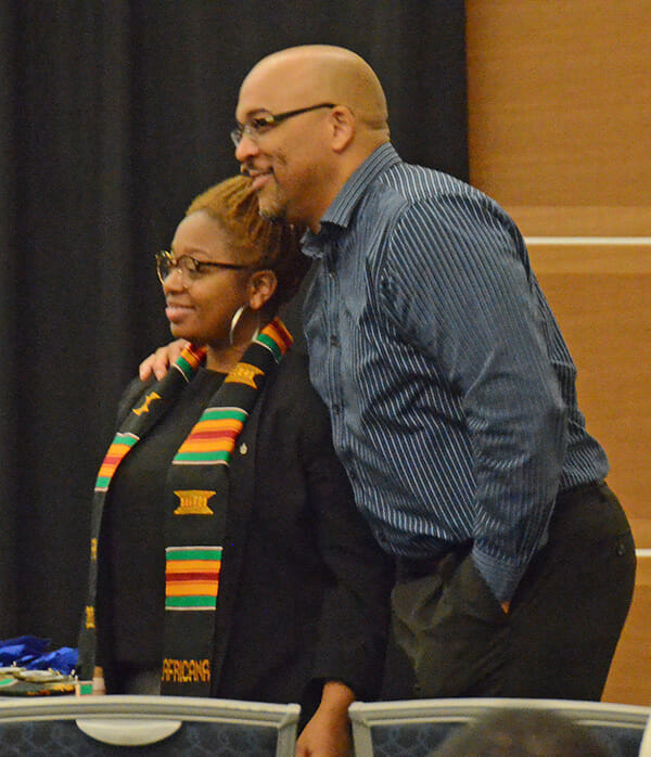 Dr. Louis Woods, director of the Africana Studies program, right, poses for a photo of graduating senior Arionna White after presenting her with the program’s special kente cloth stole during the 2018 Intercultural Graduation Reception held Nov. 19 inside the Student Union Ballroom. (MTSU photo by Jimmy Hart)