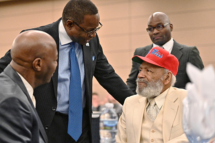 MTSU President Sidney A. McPhee, left, chats with civil rights trailblazer James Meredith, clad in white suit and red ball cap, the keynote speaker at the 23rd annual Unity Luncheon Feb. 14 at MTSU. (MTSU photo by J. Intintoli)