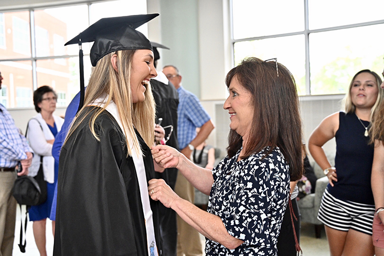 MTSU golfer Hanley Long, left, and mother Lisa Long share proud moment Tuesday, April 23, at a special commencement ceremony for student athletes who have upcoming competition commitments and will be unable to attend the regular May 4 commencement at Murphy Center. The special ceremony was held in the second floor atrium of the Miller Education Center on Bell Street. (MTSU photo by J. Intintoli)