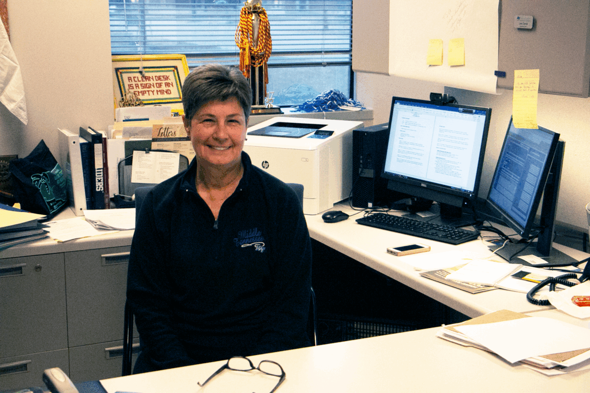 Lara Daniel sits at her desk, smiling.