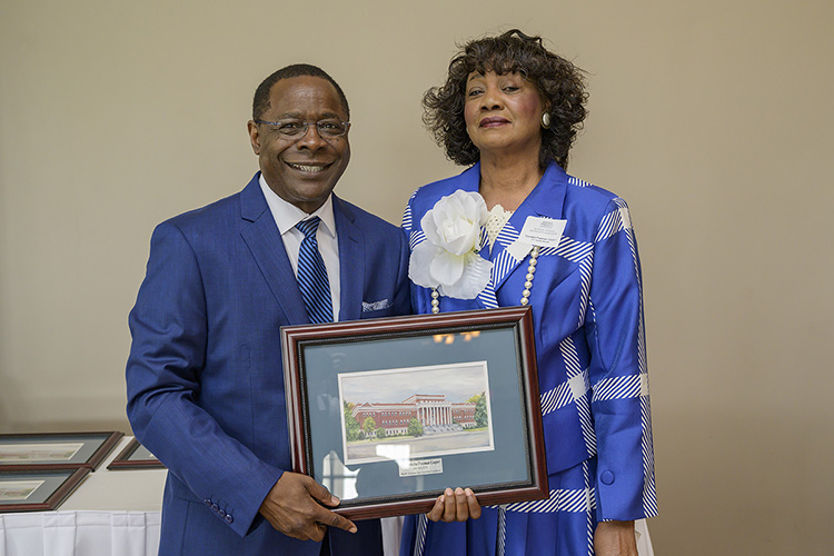 MTSU President Sidney A. McPhee, left, presents Cornelia Freeman Cooper, a new 1911 Society member, with a framed rendering of Kirksey Old Main at the seventh annual 1911 Society Luncheon held April 11 at the Stones River Country Club in Murfreesboro. The luncheon honors longtime and estate plan donors to MTSU. (MTSU photo by Andy Heidt)