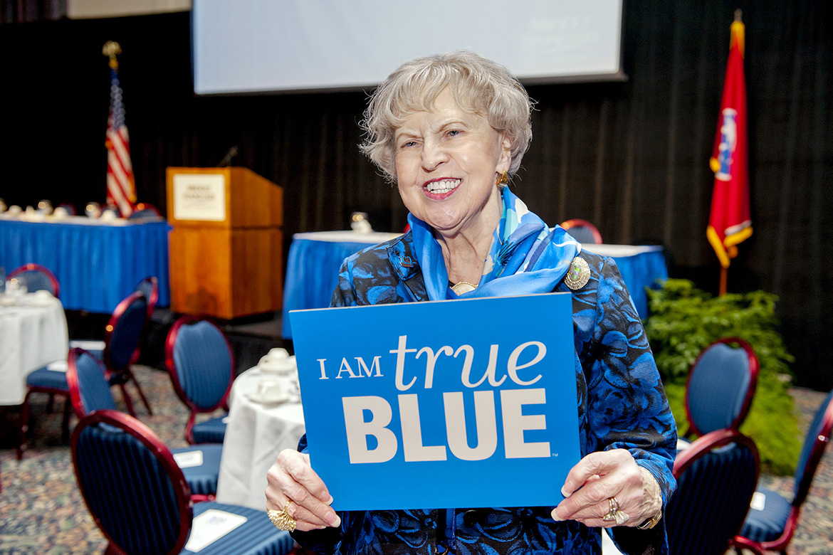 One of MTSU’s most loyal alumni, Dr. Liz Rhea proudly displays hwe “I AM true BLUE” sign during a university Capital Campaign luncheon. The Murfreesboro resident and Eagleville, Tenn., native died Thursday, May 30. (MTSU file photo by Andy Heidt)