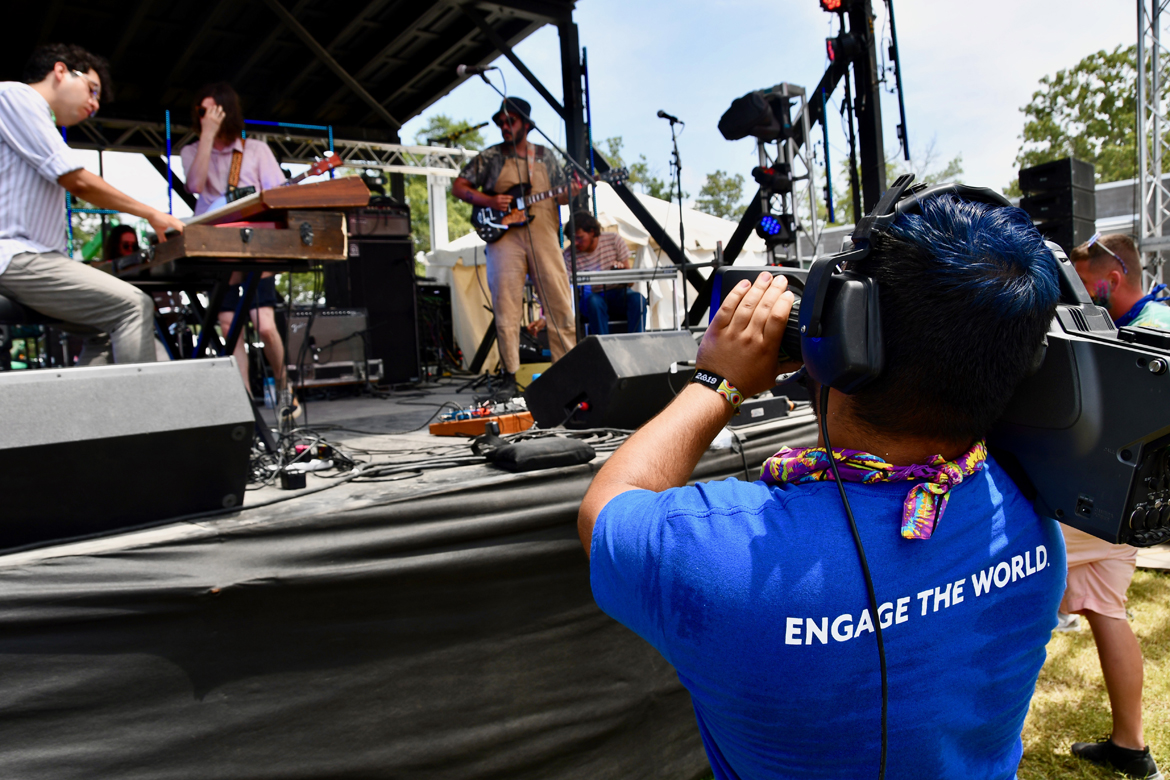 Taylor Sullivan, a music business and video production major at MTSU, gets up close to the action Sunday, June 16, while filming a concert on the Bonnaroo Who Stage in Manchester, Tenn. (MTSU photo by Andrew Oppmann)