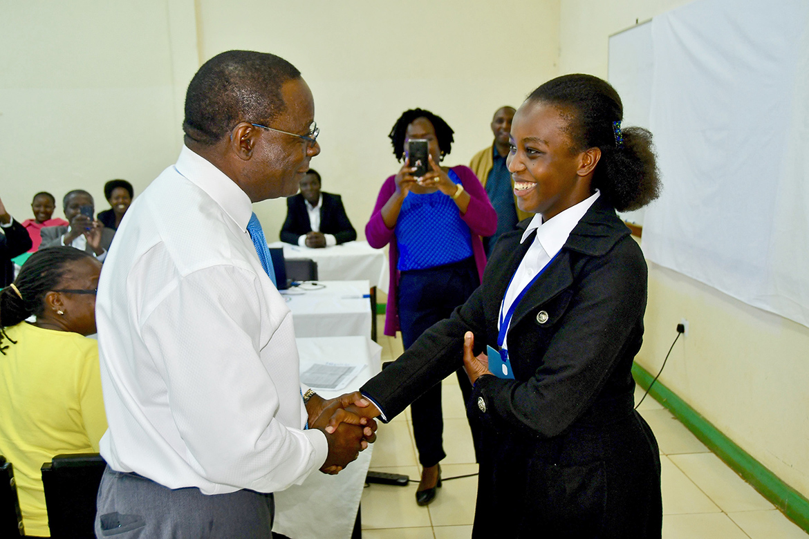 MTSU President Sidney A. McPhee congratulates Moi University student Linda Cheruto Tapkokwa, who delivered a presentation for him on her ambition and work to become a professional pilot through the School of Aerospace Sciences. (MTSU photo by Andrew Oppmann)