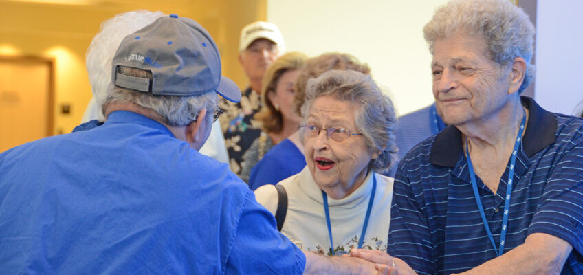 Alumni Summer College attendees Helen (Classes of 1968, ’69, ’70 and ’72), center, and Glen (’69, ’86) Emery greet fellow MTSU alumnus Joe Nunley Jr. (’69, ’74) in a blue carpet setting in the Miller Education Center. Nearly 80 alumni attended the three-day event this year. (MTSU photo by Randy Weiler)