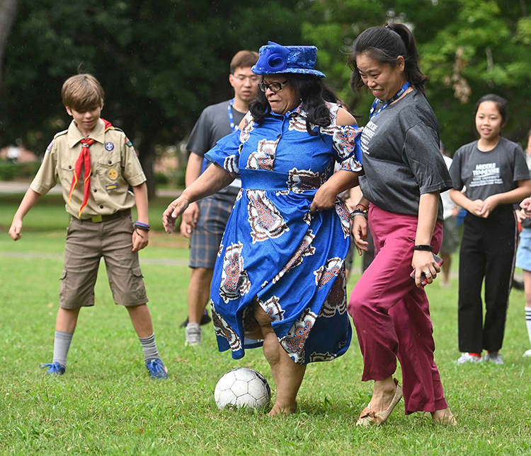 MTSU first lady Elizabeth McPhee, center in hat, plays soccer Sunday on the lawn of the President’s Residence on campus with members of the delegation from China’s Dongcheng Education Group. MTSU President Sidney A. McPhee and his wife hosted the group of middle school students for a picnic as part of their cultural exchange visit. (MTSU photo by Kimi Conro)