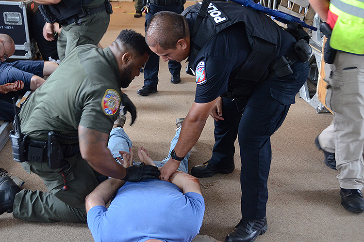 MTSU Police Cpl. Ricky Morales, right, and Rutherford County Sheriff’s Deputy Trey Mosby check on a “wounded victim” play-actor as part of a training session scenario held in early August inside MTSU’s College Heights Building as part of a comprehensive course to train more than 1,200 emergency responders across the county by the end of the year. (MTSU photo by Jimmy Hart)