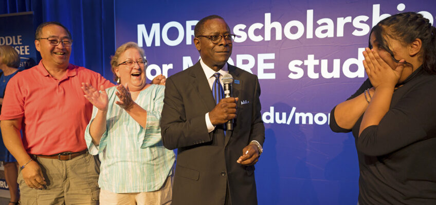 Prospective MTSU student Aelmira Esmaeilpour, right reacts with surprise after MTSU President Sidney A. McPhee awarded her a Blue Raider Scholarship recently during the kickoff event for the fall True Blue Tour in the Student Union Ballroom. McPhee unveiled a new True Blue Scholarship as an added incentive available in fall 2020 for students with a 3.5 GPA or higher and with an ACT score between 23 and 24. (MTSU photo by Cat Murphy)
