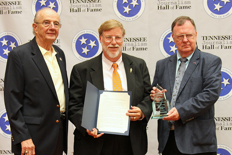 Paul Tinkle, president and general manager of Thunderbolt Broadcasting and Digital in Martin and Union City, Tenn., receives his award and certificate during the induction ceremony for the 2019 class of the Tennessee Journalism Hall of Fame held Tuesday, Aug. 6, at Embassy Suites in Murfreesboro, Tenn. Shown with him are Hooper Penuel, left, TJHOF co-founder and secretary, and TJHOF President Larry Burriss. (Submitted photo)