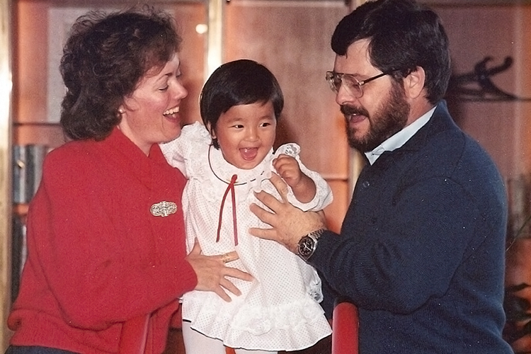 MTSU language professor Bonnie Tinsley, left, and her husband, Cliff Richeson, hold their baby daughter, Pema, in a photo from Christmas 1986 in Hong Kong. Tinsley, a guest on the Aug. 27, 2019, edition of "MTSU On the Record" on WMOT-FM Roots Radio 89.5, wrote about their quest to adopt Pema from Mother Teresa’s Missionaries of Charity orphanage in India in “Against Every Hope: India, Mother Teresa, and a Baby Girl.” (Photo submitted)