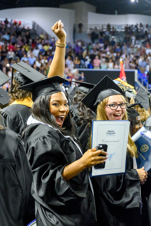 Two members of MTSU’s Class of 2019 celebrate reaching their goals Saturday, Aug. 10, during the university’s summer 2019 commencement ceremony in Murphy Center. MTSU awarded 817 degrees during the event to 603 undergrads and 214 graduate students. (MTSU photo by J. Intintoli)