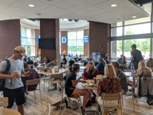 Students mill about the Farmers Market during lunch, enjoying the fresh food and good company.