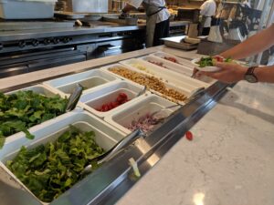 Students choose from a wide variety of salad ingredients available every day at the Farmers Market.