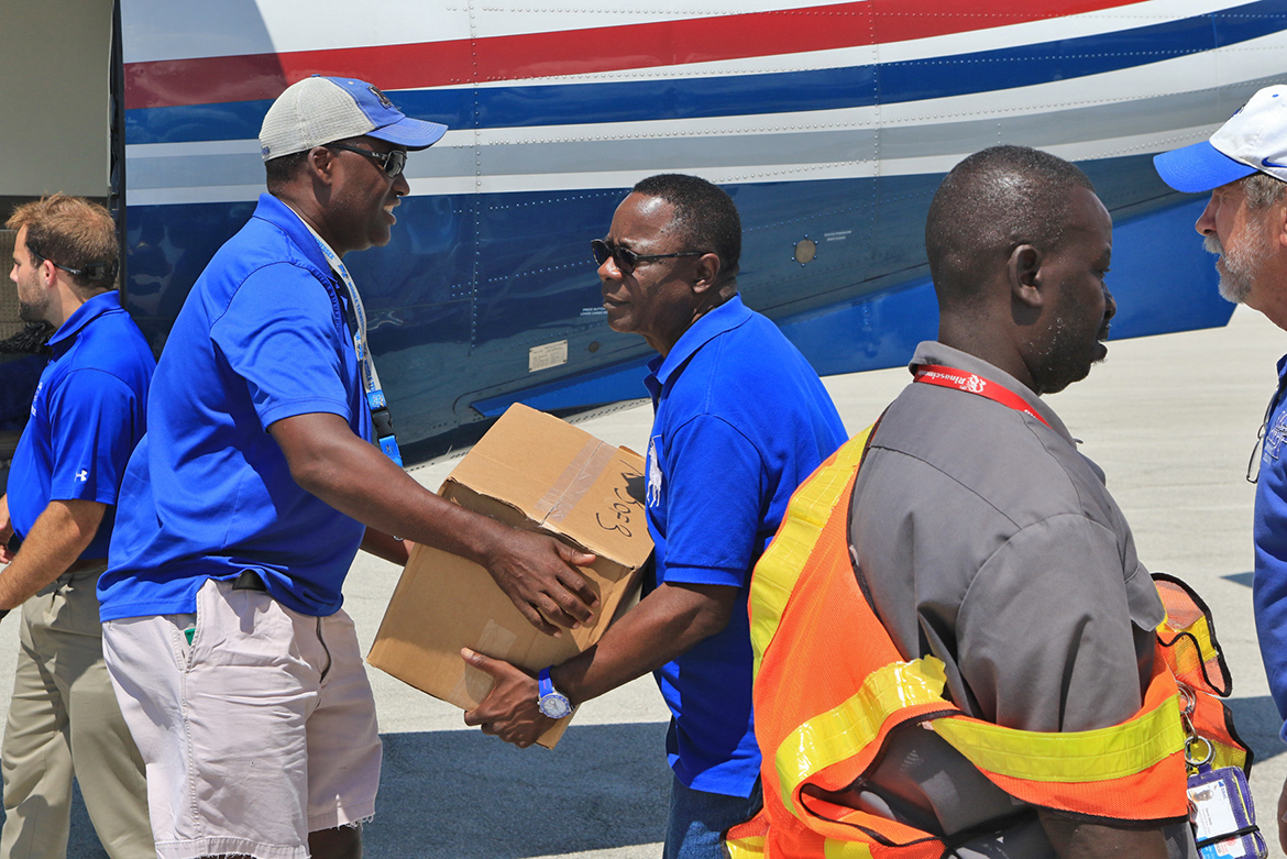 MTSU Trustees Vice Chair Darrell Freeman, left, and President Sidney A. McPhee unload supplies from aircraft that flew to the Bahamas as part of the second wave of Raider Relief on Sept. 11. (MTSU Photo by John Goodwin)