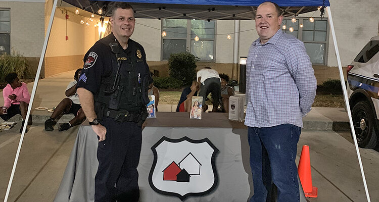 Murfreesboro Police Department Sgt. Harry Haigh, left, coordinator of the Murfreesboro Crime Free Multi-Housing program, and MPD Chief Michael Bowen, staff an event to celebrate one-year anniversary of College Center Apartments certification in the program. (Photo courtesy of the City of Murfreesboro)
