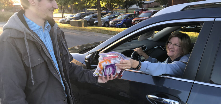 Tyler Hollis, left, a fourth-year Lipscomb University College of Pharmacy student, collects unwanted medications from Tammy Howell, a secretary in the MTSU Department of Biology, Thursday, Oct. 24, during the fall Drug Take-Back Day at the Campus Pharmacy Drive-Thru. More than 83 pounds was collected during the 5½-hour drive. (MTSU photo by Randy Weiler)