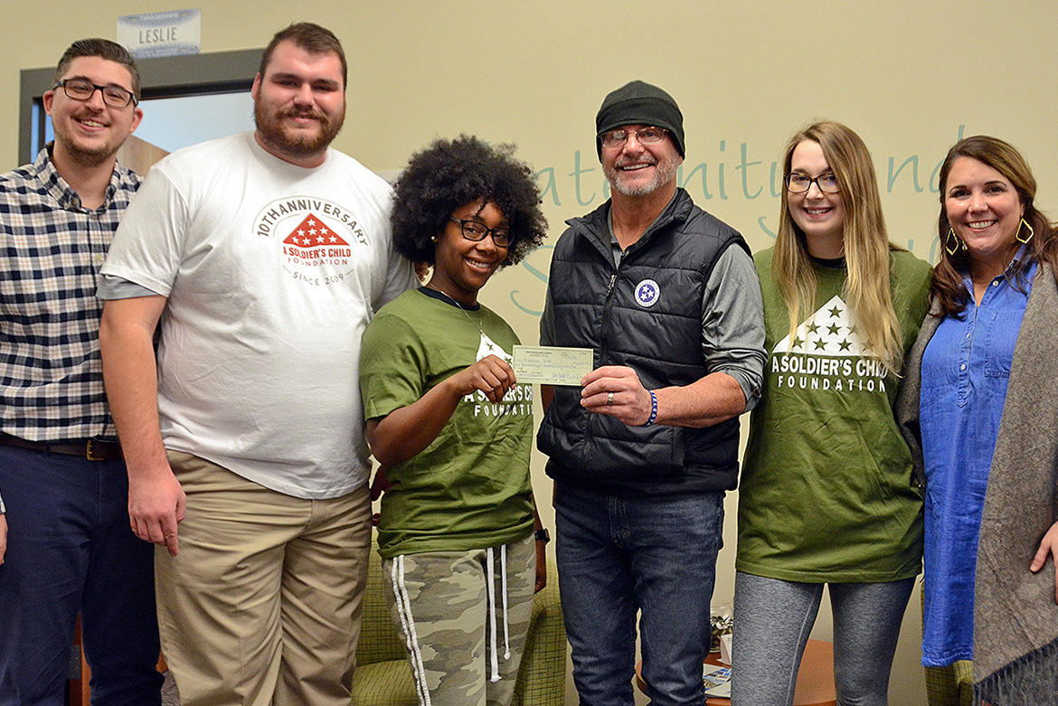 The Office of Fraternity and Sorority Life at MTSU celebrates the donation of a check for more than $6,800 to the A Soldier’s Child Foundation. From left, Jordan Borchert, coordinator, Fraternity and Sorority Life; Nate Parris, president-elect, Interfraternity Council; Terranny McLean, vice president of programming, National Pan-Hellenic Council; Daryl Mackin, founder and executive director, A Soldier’s Child Foundation; Alyssa Marchman, president-elect, National Pan-Hellenic Council; and Leslie Merritt, director, Fraternity and Sorority Life. (MTSU photo by Gina Logue)