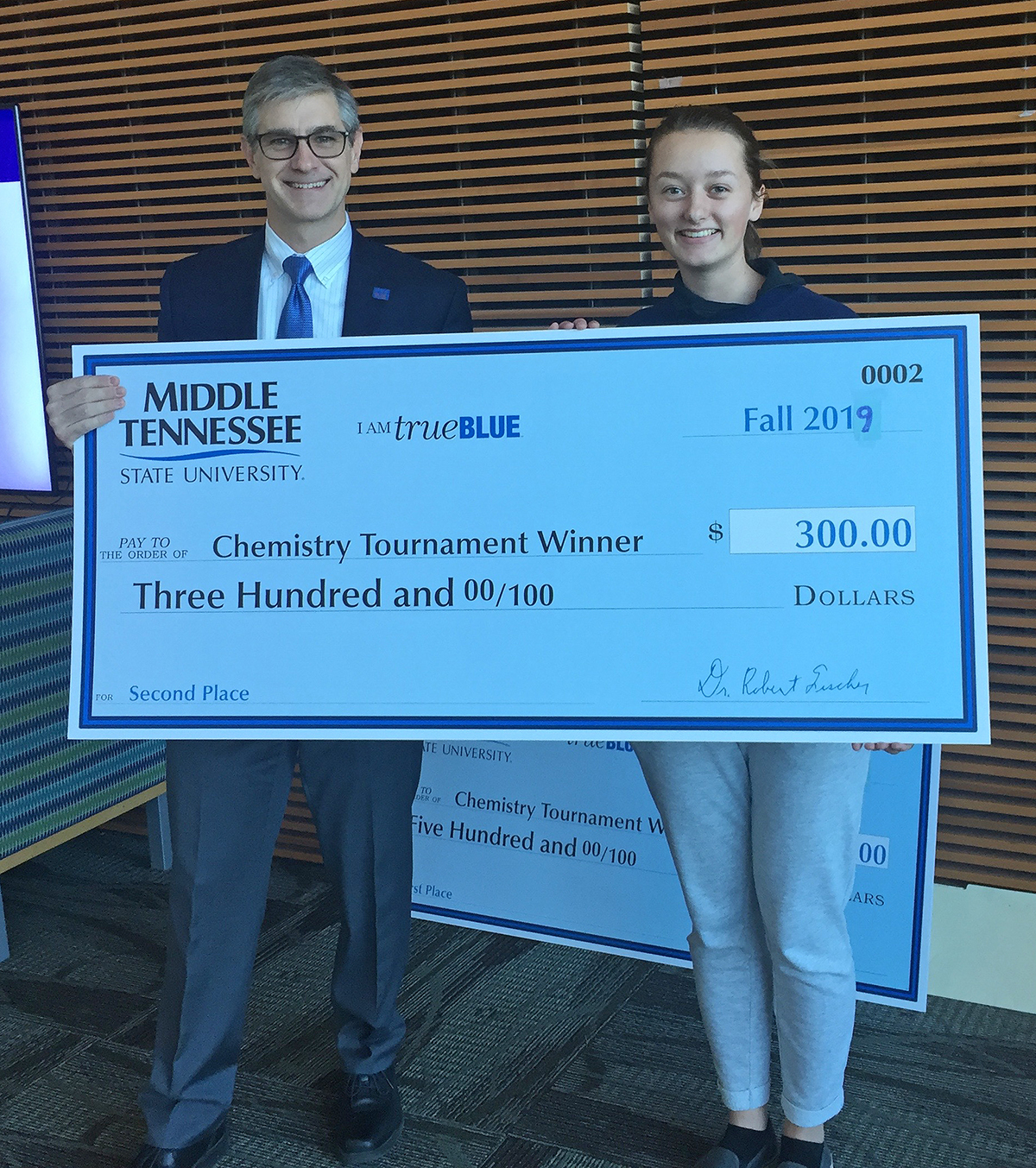 MTSU Department of Chemistry Chair Greg Van Patten, left, presented Sydney Coil with a $1,500 scholarship and $300 cash prize for finishing runner-up in November in the 2019 Chemistry Scholarship Tournament in the Science Building. Coil is a senior at Independence High School in Thompson’s Station, Tenn. (Submitted photo)